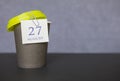 Coffee paper cup with calendar dates for August 27, summer season. Time for relaxing breaks and vacations