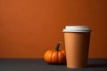 Coffee in a paper cup on a plain brown background, copy space
