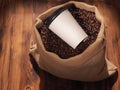 Coffee paper cup in sackcloth bag on wood background Royalty Free Stock Photo