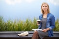 Coffee, park and woman on bench thinking with books for lunch break, relax and calm in nature. Contemplating, reading Royalty Free Stock Photo