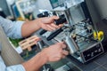 Coffee Passion. Young barista at coffee shop holding pitcher steaming milk close-up