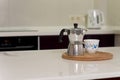 Coffee percolator and cup on a kitchen counter Royalty Free Stock Photo