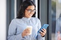 Coffee, phone and business woman on a break in the office networking on social media, mobile app or internet. Happy Royalty Free Stock Photo