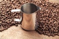 Coffee pitcher and beans on old wooden table