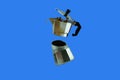 Coffee pot falling on a blue background