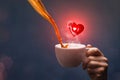 Coffee pouring into a cup with heart notification symbol Royalty Free Stock Photo