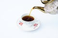 The coffee is pouring into the cup from a kettle. Royalty Free Stock Photo