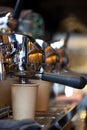 Coffee pouring from professional espresso machine into take away paper cup Royalty Free Stock Photo