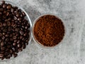 Coffee powder in bowl with defoused beans in saucer Royalty Free Stock Photo