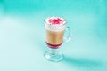 Coffee raff with raspberries in a glass cup with a handle