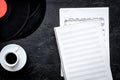 Coffee and records with paper note in music studio for dj or musician work on dark background top view mock-up Royalty Free Stock Photo