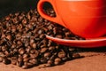 Coffee in red cup and coffee beans are the background. Royalty Free Stock Photo