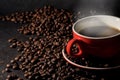 Coffee in red cup and coffee beans are the background. Royalty Free Stock Photo