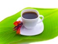 Coffee and red flower on leaf Royalty Free Stock Photo