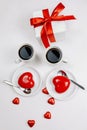 Coffee and red heart-shaped cakes. Romantic evening at home for two with candles on the table Royalty Free Stock Photo