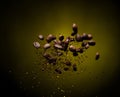 Coffee roasted bean ground fly explosion, Coffee crushed ground float pouring mix with beans. Roasted Coffee bean powder ground Royalty Free Stock Photo