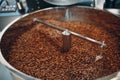 Coffee roaster machine at coffee roasting process. Mixing coffee beans.