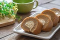 Coffee roll cake with cream on plate and coffee cup Royalty Free Stock Photo