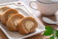 Coffee roll cake with cream on plate and coffee cup Royalty Free Stock Photo