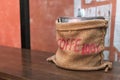 Coffee sack on wooden table. Royalty Free Stock Photo