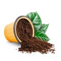 Coffee scattered from capsule with green leaves isolated