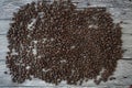 Lots of coffee beans on a wooden table