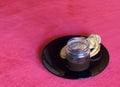 Coffee served in a jar on a black plate with palmier pastries on a red tablecloth Royalty Free Stock Photo