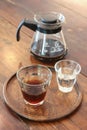 Coffee set on the wooden table, a glass of americano coffee and the water in the coffee shop.