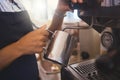 Coffee shop, barista and waitress working in a cafe and pouring a fresh drink in a restaurant while in an apron. Closeup Royalty Free Stock Photo