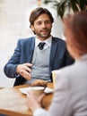 Coffee shop business discussions. A businessman and woman having a meeting over coffee. Royalty Free Stock Photo