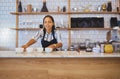 Coffee shop, employee or worker of a woman in a retail business handing warm beverages on a counter at a cafe. Barista