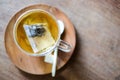 In coffee shop, the hot lavender tea in glass serve with wooden spoon & saucer on the table for relax and slow life concept Royalty Free Stock Photo