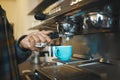 Coffee shop machine handle, hand of barista brewing espresso in restaurant and closeup of hot water beverage in cafe