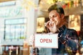Coffee shop, open sign and a man small business owner standing a glass door for service or hospitality. Cafe, manager or Royalty Free Stock Photo