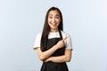 Coffee shop, small business and startup concept. Enthusiastic smiling young asian woman working in cafe, waitress or Royalty Free Stock Photo