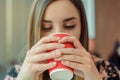Coffee shop tasty hot morning beverage takeaway to go paper red cup tea enjoy face happiness hands holding concept. Close up view Royalty Free Stock Photo