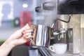 Coffee shop worker preparing coffee on steam espresso coffee machine Royalty Free Stock Photo