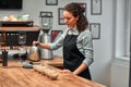 Coffee shop workers checking coffee quality during coffee food function. Side view