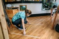 Coffee shop workers measuring floor marks