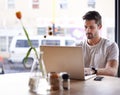 Coffee shop, working and serious man with laptop and code work in a cafe. Tech, email and male freelancer customer at a Royalty Free Stock Photo