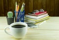 Coffee,smart phone,glasses,and stack of book on wooden Royalty Free Stock Photo