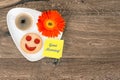 Coffee with smiling cookie and daisy flower Royalty Free Stock Photo