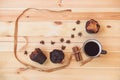 Coffee, spices and muffins on wooden background.