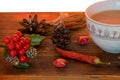 Coffee, spices and pine cones on a wooden background. Christmas concept. A cup of hot coffee with milk, cinnamon and chili on a wo Royalty Free Stock Photo