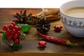 Coffee, spices and pine cones on a wooden background. Christmas concept. A cup of hot coffee with milk, cinnamon and chili on a wo Royalty Free Stock Photo