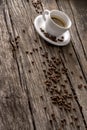 Coffee with spilled beans on wooden table Royalty Free Stock Photo