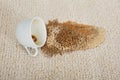 Coffee Spilling From Cup On Carpet Royalty Free Stock Photo