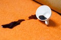 Coffee spilling from cup on carpet. Domestic life. The concept of cleaning stains. Royalty Free Stock Photo