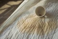 Coffee stain on a bed in bright morning light Royalty Free Stock Photo