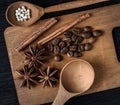 coffee, star anise, cinnamon, spoon on wooden cutting Board and dark background Royalty Free Stock Photo